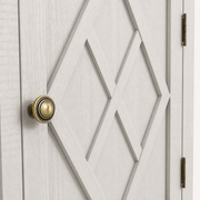 Hardware | round antique-brass ringed knob set against the X-diamond door overlay