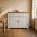 In a room | wine cabinet against an ivory plaster wall, warm late-afternoon light from a window on the right