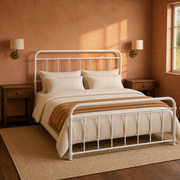 Clay corner | White bed viewed from the corner in a terracotta room with wood nightstands