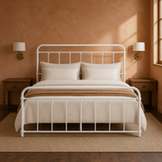 Clay room | White spindle bed against a warm terracotta wall with brass sconces