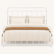 Detail | Close front view of the rounded white rails and vertical spindles