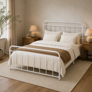 Angle | White spindle bed viewed from the foot corner with bedding and a warm neutral rug