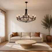 Living room | the chandelier hung above a sofa and round stone coffee table