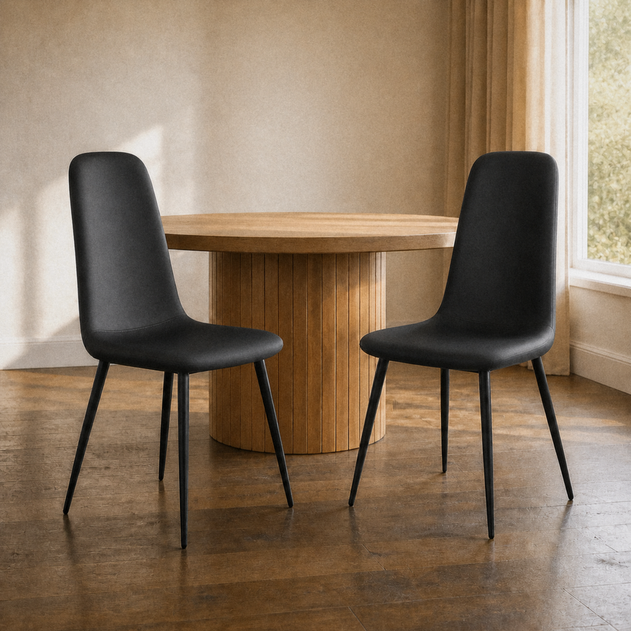 In a room | the pair pulled up to a table in a warm plaster dining room, afternoon light from the right