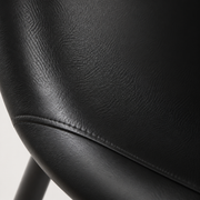 Closer | midnight-black vegan-leather grain and the single top-stitch seam