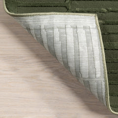 Folded corner | one corner turned back on a wood floor to show the backing