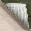 Folded corner | one corner turned back on a wood floor to show the backing