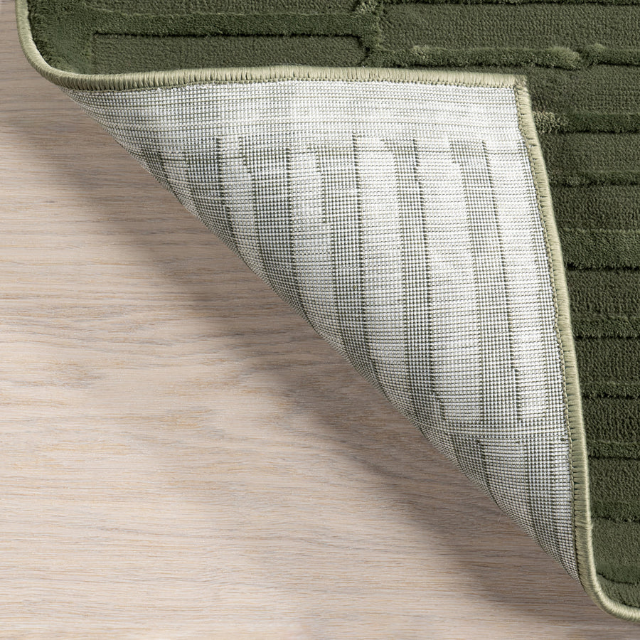 Folded corner | one corner turned back on a wood floor to show the backing