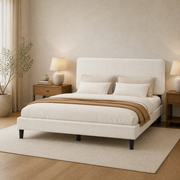 Bedroom scene | Upholstered bed with white bedding in a bright room with light wood accents