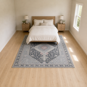Bedroom | the rug styled under a bed in a bright bedroom