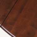 Texture | close-up on the espresso rubberwood grain across the tabletop near a leaf seam