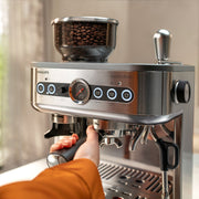 Detail | Close-up of the 58mm portafilter, tamping station, and dual bean container system