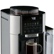 Detail | Coffee beans in the TrueBrew built-in grinder hopper above the control panel and brewing mug