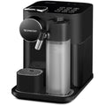 Angle | black single-serve espresso and coffee machine at a three-quarter angle with the milk-frothing jug attached and the drip tray raised