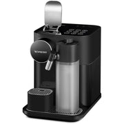 Detail | black espresso machine with the capsule lid lifted open above the control buttons, milk jug in place