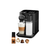 Angle | black machine with the milk-frothing jug attached beside a box of coffee capsules