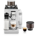 Front | white Rivelia straight on with the milk carafe fitted, a cappuccino under the spout, an espresso and a spare bean hopper beside it