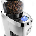 Hopper detail | clear bean hopper full of coffee beans above the backlit display and cup-dose buttons of the silver grinder