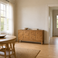 In scale | sideboard against the wall with an open doorway alongside for size reference, ceramic bowl and books on top