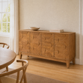 Room angle | same flax dining room, sideboard at a true three-quarter so the faceted doors and tapered legs both read