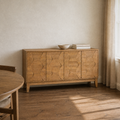 Third room | same sideboard in an ivory dining room with a smoked oak floor, warm afternoon window light on the faceted doors