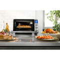 In use | De'Longhi air fryer oven installed on kitchen countertop with food inside