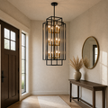 In a room | the same lantern chandelier hanging in a warm entryway beside a console table