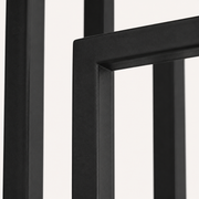 Texture | close view of the matte black iron bars and brass center pole