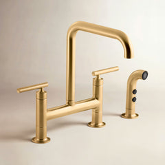 Kohler Purist Two Handle Deck-Mounted Bridge Kitchen Sink Faucet with Side Spray in Vibrant Brushed Moderne Brass | product photo