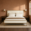Clay room | Front bedroom view against a warm clay wall with brass sconces and the cream tufted bed