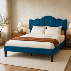 Room 1 angle | Three-quarter studio view showing the arched panel headboard, upholstered rails, and dark tapered legs
