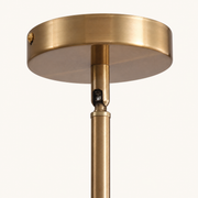 Hardware | close-up of the Marnau Glazenn chandelier's brass ceiling canopy and downrod, showing the swivel coupling used for sloped-ceiling installs