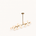 Studio | three-quarter angle of the Marnau Glazenn 16-light sputnik chandelier on a plain background, showing the brass arms and frosted glass globes from a rotated view