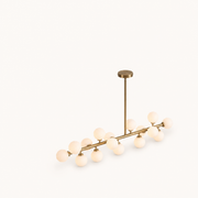 Studio | three-quarter angle of the Marnau Glazenn 16-light sputnik chandelier on a plain background, showing the brass arms and frosted glass globes from a rotated view