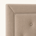 Detail | Mitered upholstered headboard corner with piped inset and tuft button