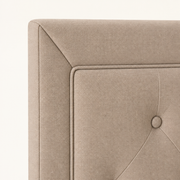 Detail | Mitered upholstered headboard corner with piped inset and tuft button