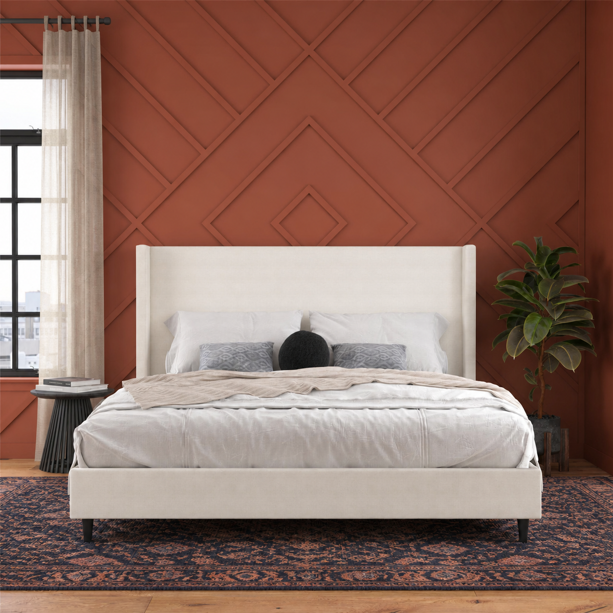 Burnt-sienna bedroom | Textured ivory canvas wingback bed with preserved bedding and an indigo-rust rug
