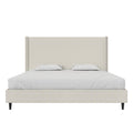 Studio front | Textured ivory canvas wingback bed with bedding, straight headboard and black tapered legs