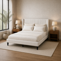 Warm ivory bedroom angle | Ivory wingback bed with walnut nightstands and a full window