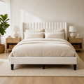 Blue-gray bedroom | Ivory channel-tufted wingback bed with black nightstands