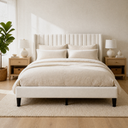Blue-gray bedroom | Ivory channel-tufted wingback bed with black nightstands