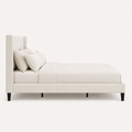 Studio side | Right profile of Ivory upholstered bed with wingback headboard and black legs