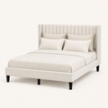 Studio angle | Front-right view of Ivory upholstered wingback bed and black tapered legs