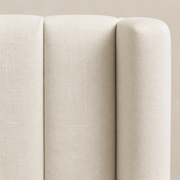 Linen detail | Ivory cross-hatch upholstery with a narrow channel seam and rounded wing edge