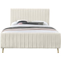 Studio front | Cream velvet channel-tufted platform bed with curved footboard and gold legs