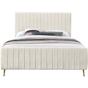 Studio front | Cream velvet channel-tufted platform bed with curved footboard and gold legs