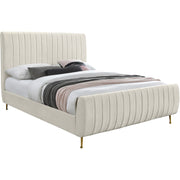 Studio angle | Cream velvet channel-tufted platform bed with upholstered rails and gold legs