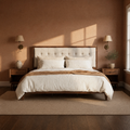 Terracotta bedroom | Walnut and light linen platform bed with brass sconces