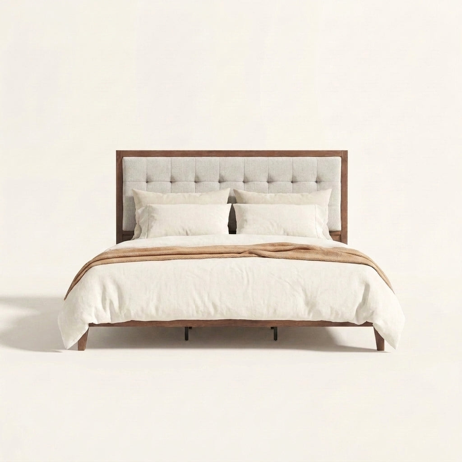 Studio front | Walnut platform bed with square-tufted light linen headboard and tapered legs
