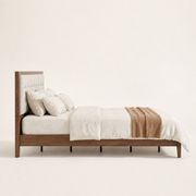 Studio side | Right profile of walnut platform bed with low rail and center support feet
